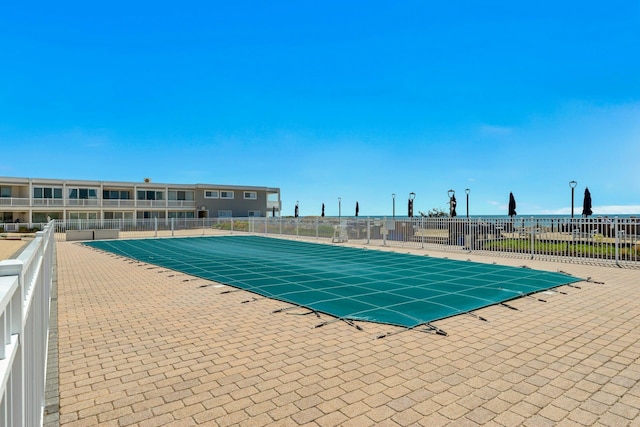 pool featuring a patio and fence