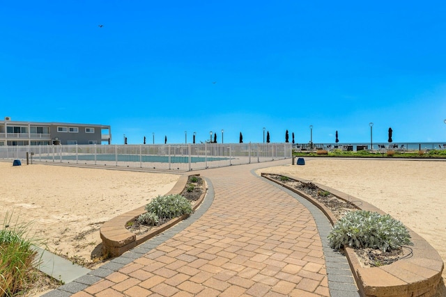 view of home's community featuring fence and a pool