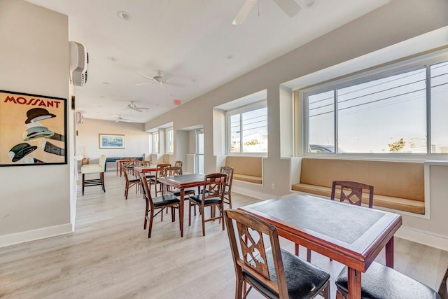 dining area featuring baseboards, ceiling fan, and light wood-style flooring