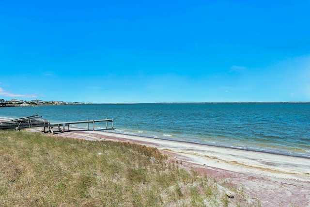 water view featuring a beach view and a boat dock