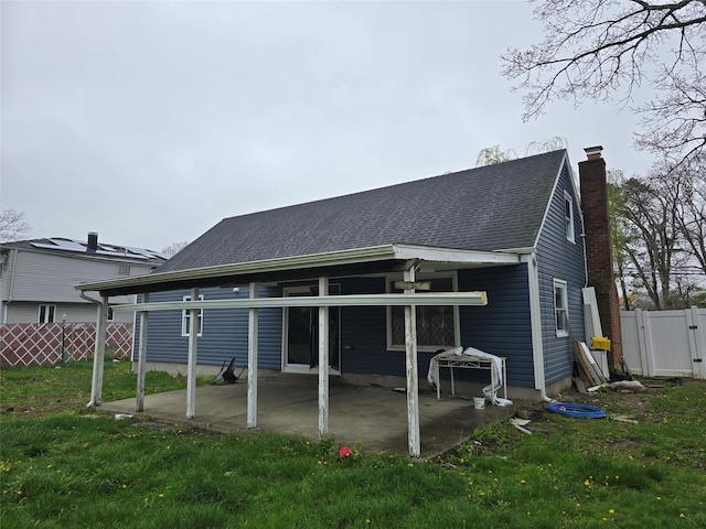 rear view of house featuring fence, a chimney, a gate, and a patio area