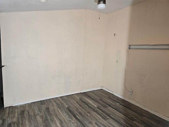 spare room with baseboards, dark wood-style flooring, and ceiling fan