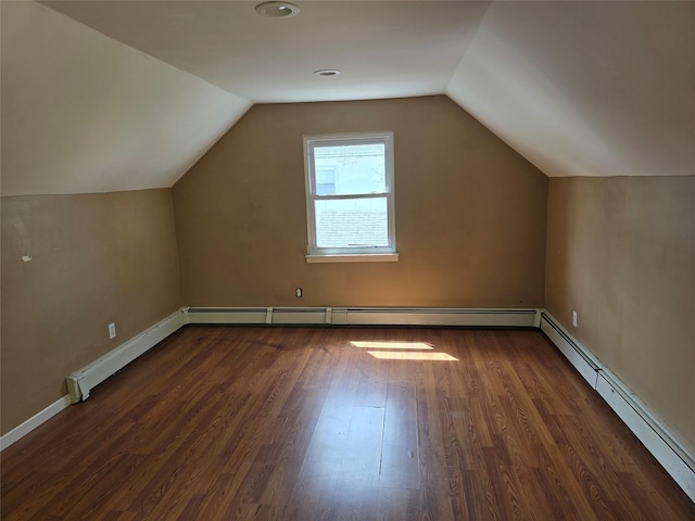 additional living space featuring baseboards, baseboard heating, wood finished floors, and lofted ceiling