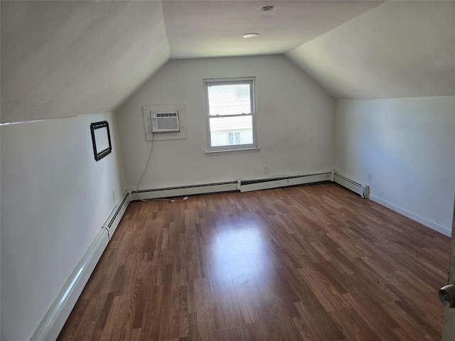 additional living space with wood finished floors, a baseboard heating unit, lofted ceiling, and a wall mounted AC