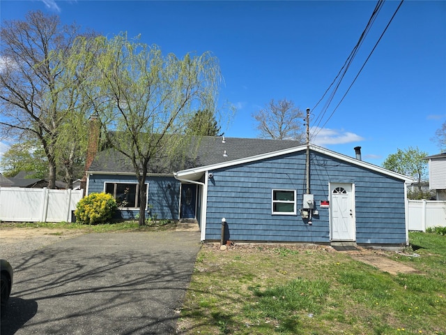 view of front of house with fence and a chimney