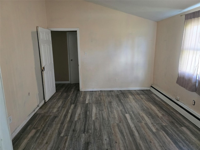 spare room with baseboards, a baseboard radiator, and wood finished floors