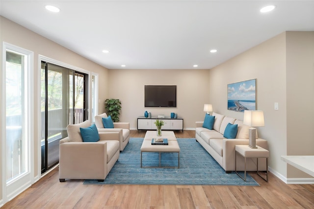 living area featuring recessed lighting, baseboards, and wood finished floors