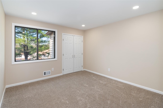 unfurnished bedroom with visible vents, recessed lighting, baseboards, and carpet floors