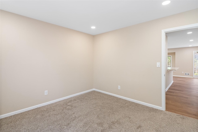 spare room featuring baseboards, carpet flooring, recessed lighting, and visible vents