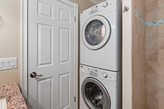 clothes washing area featuring stacked washer / dryer