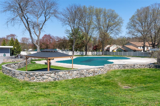 view of swimming pool with a yard, a gazebo, and fence