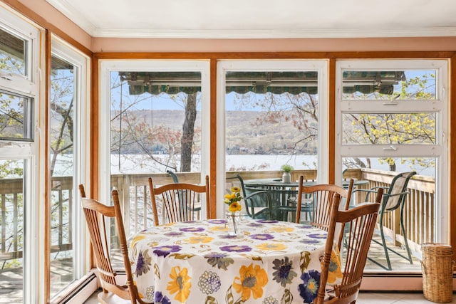 sunroom / solarium featuring ornamental molding, a baseboard heating unit, and plenty of natural light