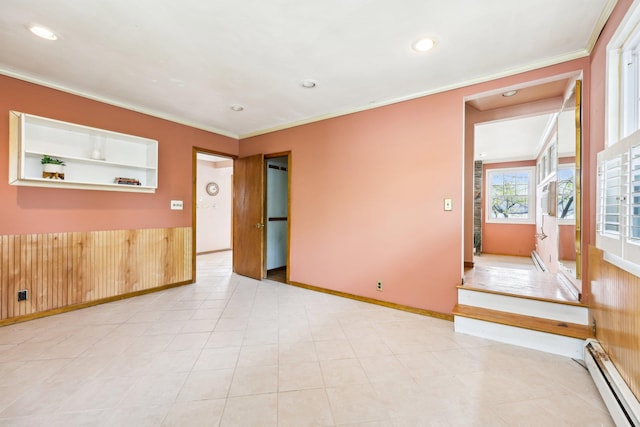 empty room with baseboards, recessed lighting, crown molding, and a baseboard radiator