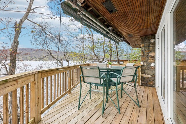wooden deck featuring outdoor dining area