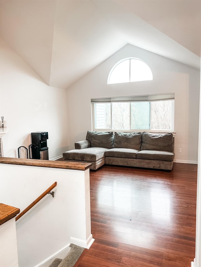 living room with baseboards, dark wood finished floors, and vaulted ceiling