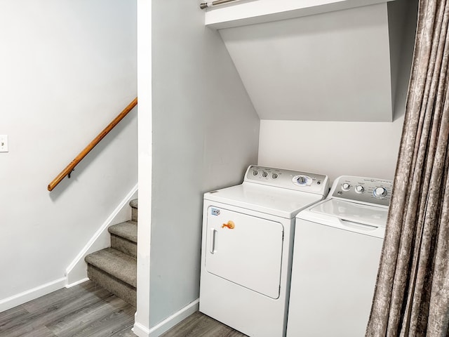 laundry area featuring baseboards, separate washer and dryer, laundry area, and wood finished floors