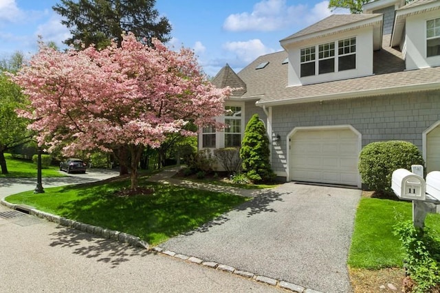 11 Pond View Ln, Ossining, NY 10562 - view of front of house featuring aphalt driveway, a front lawn, and roof with shingles