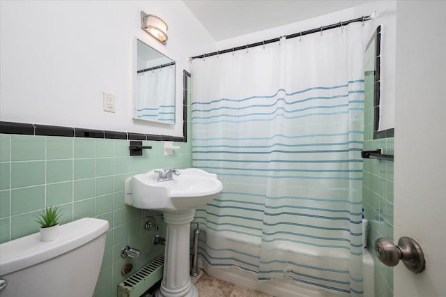10 Bryant Cres Unit 2A, White Plains, NY 10605 - bathroom featuring toilet, tile walls, tile patterned floors, a wainscoted wall, and shower / bath combo