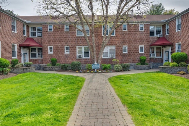 10 Bryant Cres Unit 2A, White Plains, NY 10605 - view of front of property with brick siding, cooling unit, and a front lawn