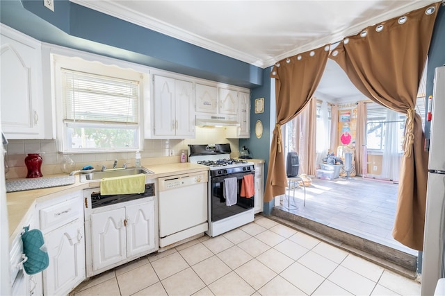 kitchen featuring white dishwasher, light countertops, under cabinet range hood, and gas range oven