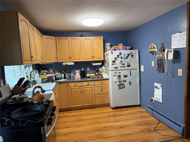 11 Columbus Ave, Brentwood, NY 11717 - kitchen featuring a sink, stainless steel range with gas cooktop, light wood-style flooring, baseboard heating, and freestanding refrigerator