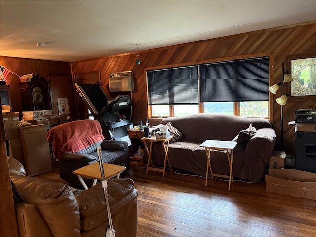 11 Columbus Ave, Brentwood, NY 11717 - living area featuring hardwood / wood-style flooring, wooden walls, and an AC wall unit