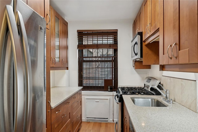 212-03 75th Ave Unit 5A, Bayside, NY 11364 - kitchen with appliances with stainless steel finishes, brown cabinetry, a sink, and glass insert cabinets
