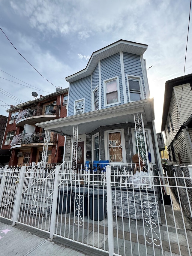 33-40 101st St, Corona, NY 11368 - view of property featuring a fenced front yard and covered porch