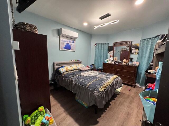 33-40 101st St, Corona, NY 11368 - bedroom featuring recessed lighting, a wall mounted AC, and wood finished floors