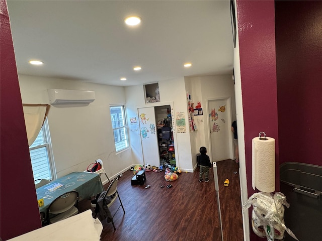 33-40 101st St, Corona, NY 11368 - interior space featuring wood finished floors, a wall unit AC, recessed lighting, and baseboards