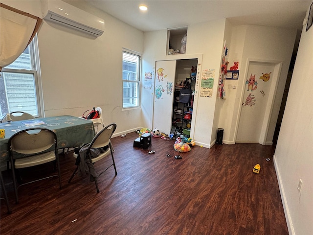33-40 101st St, Corona, NY 11368 - dining area featuring wood finished floors, a healthy amount of sunlight, a wall mounted AC, and baseboards