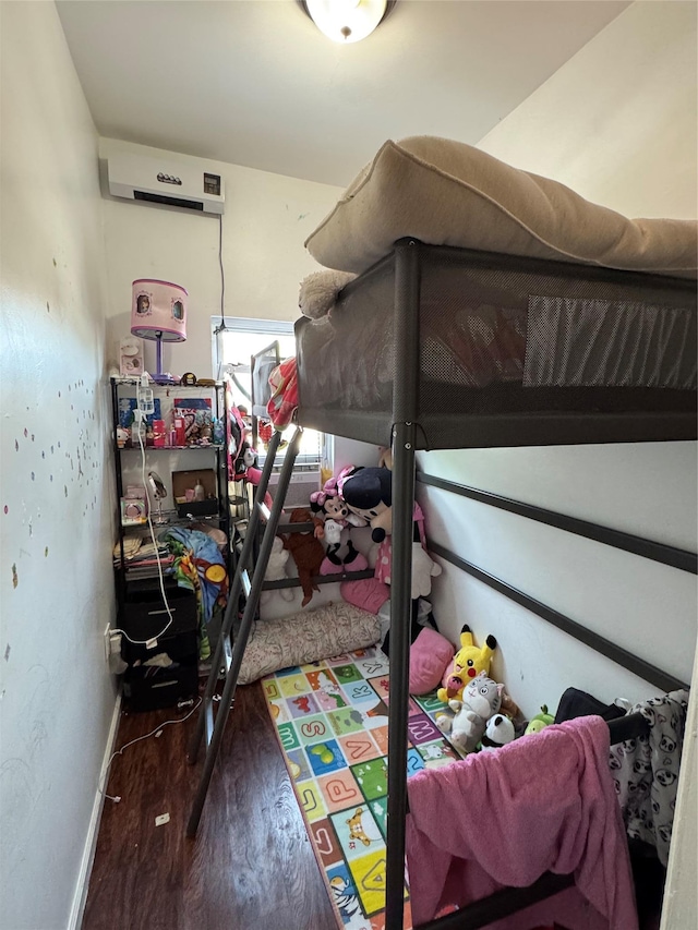33-40 101st St, Corona, NY 11368 - bedroom featuring baseboards, wood finished floors, and a wall mounted AC