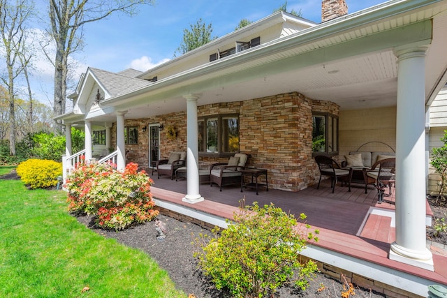 rear view of property featuring a deck, an outdoor living space, a chimney, and a yard