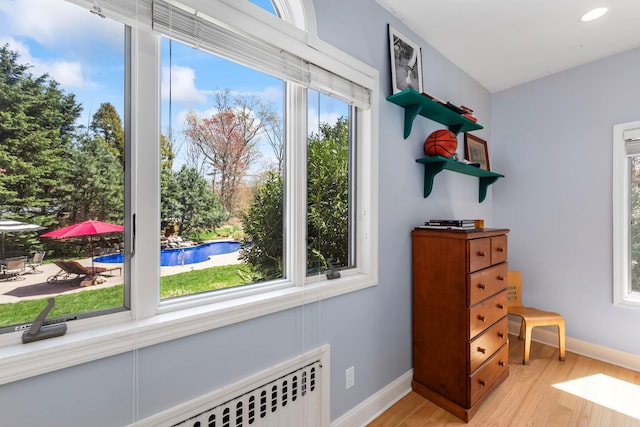 interior space with baseboards, recessed lighting, and light wood finished floors