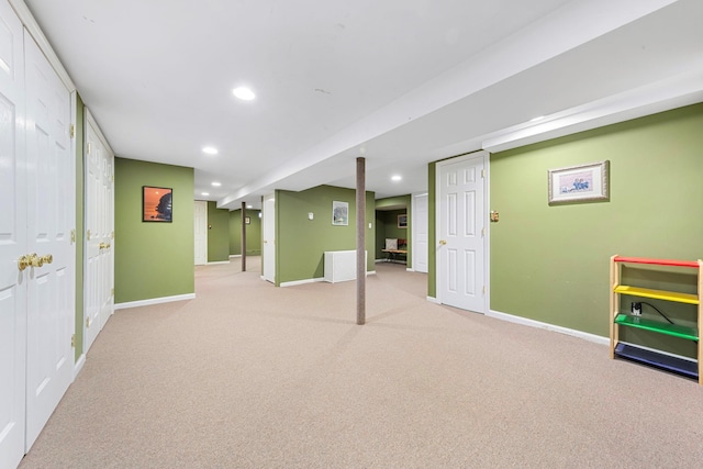 finished basement with baseboards, recessed lighting, and light colored carpet