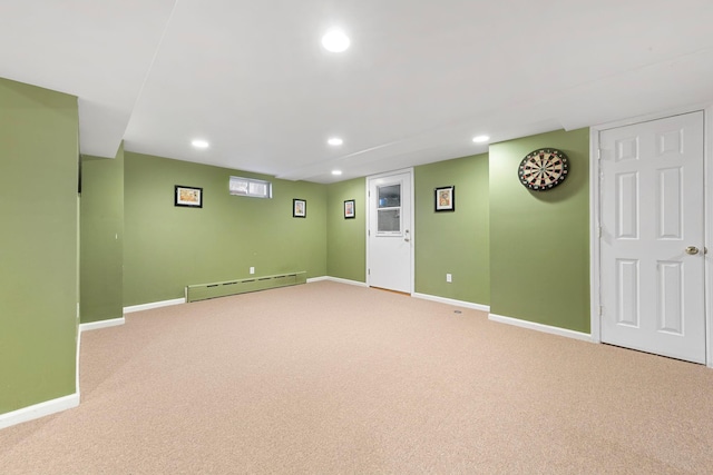 finished basement featuring recessed lighting, baseboards, light colored carpet, and a baseboard radiator