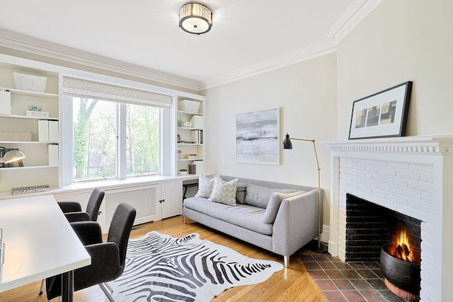 office area featuring radiator heating unit, crown molding, a fireplace, and wood finished floors