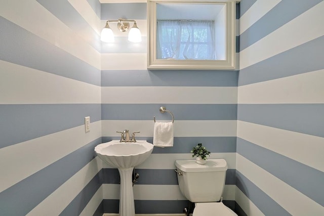 half bathroom featuring toilet