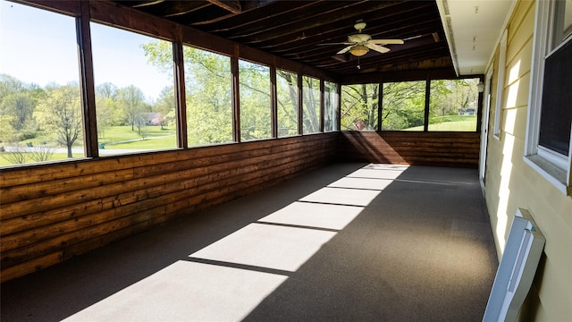 unfurnished sunroom featuring ceiling fan