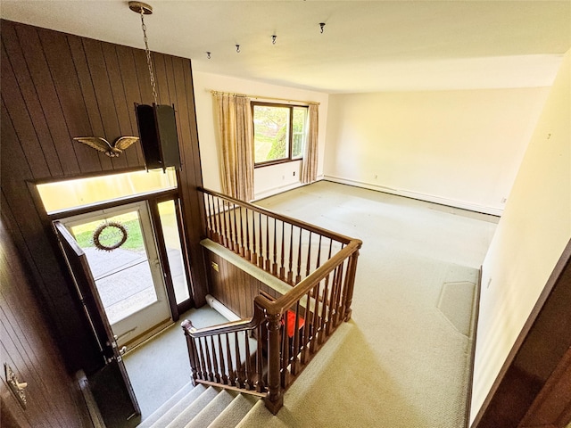 stairs featuring carpet flooring and baseboards