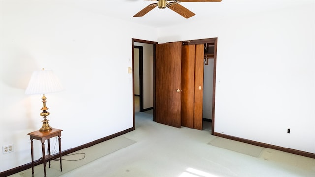 unfurnished bedroom with light colored carpet and baseboards