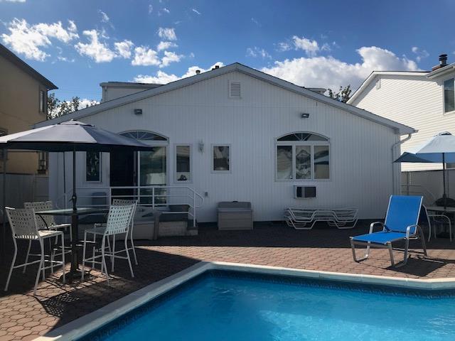 158-35 91st St, Howard Beach, NY 11414 - rear view of house with entry steps, a gazebo, an outdoor pool, and a patio area