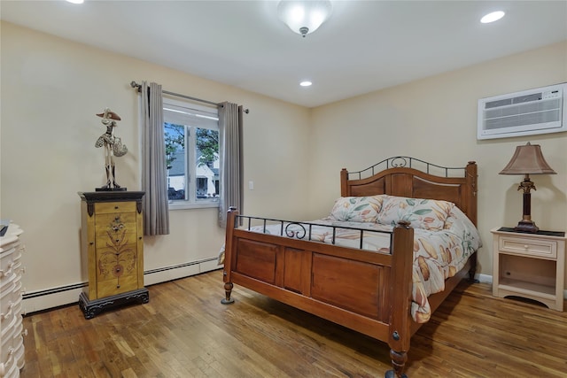 158-35 91st St, Howard Beach, NY 11414 - bedroom with a baseboard radiator, a wall unit AC, recessed lighting, and wood finished floors