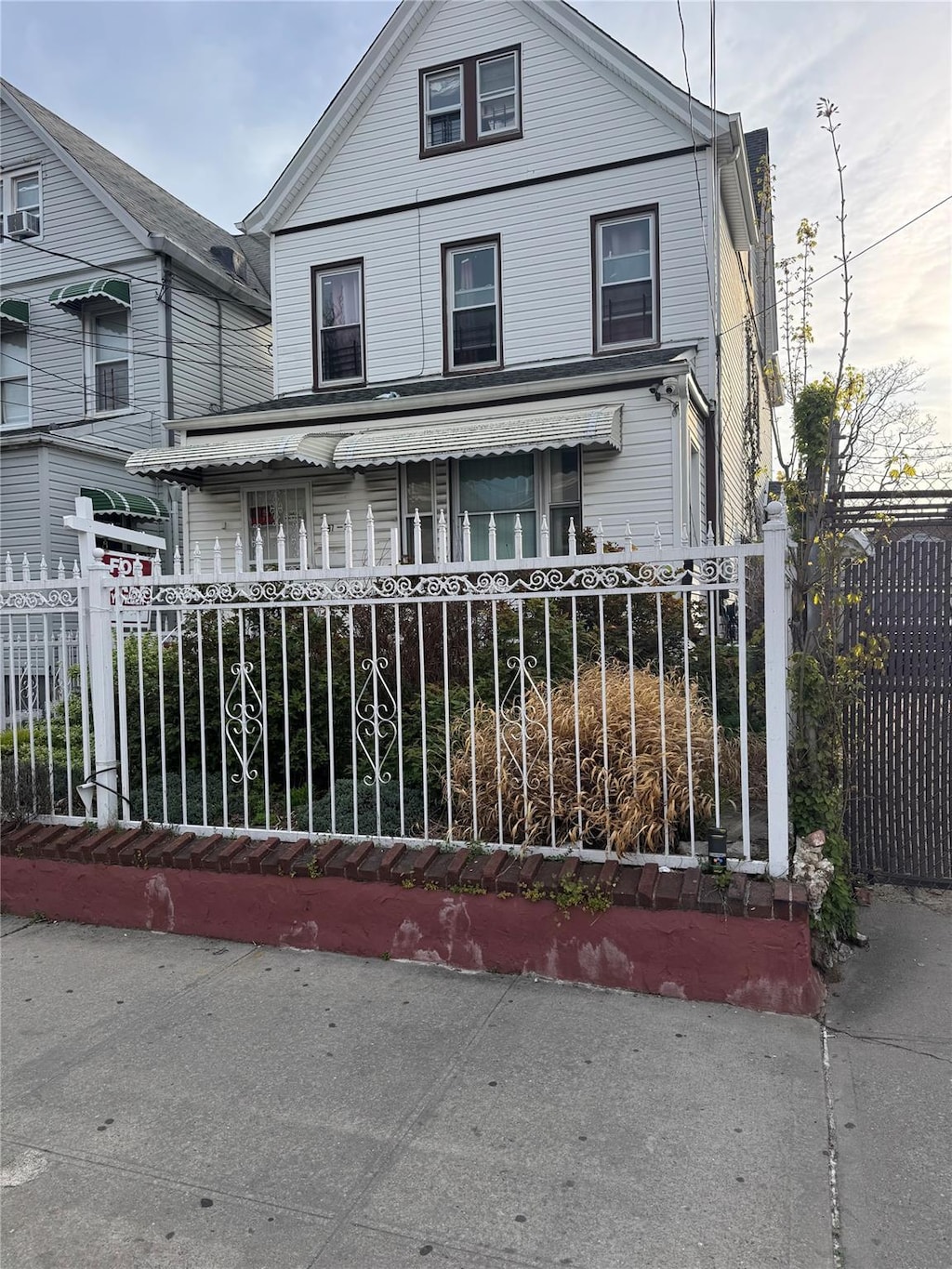97-39 110th St, Richmond Hill, NY 11419 - view of front facade with covered porch and a fenced front yard