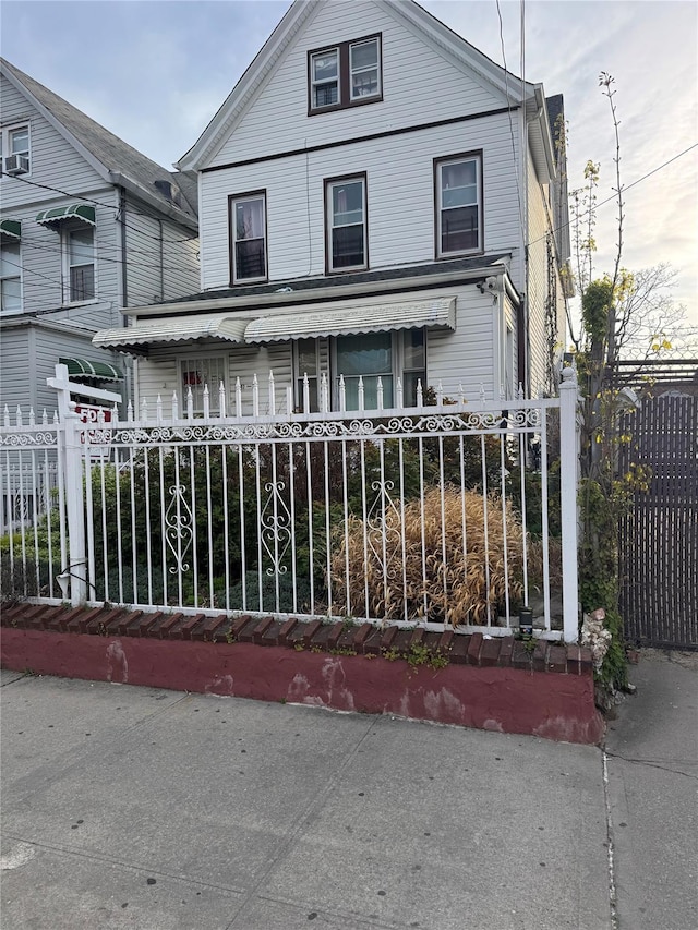 97-39 110th St, Richmond Hill, NY 11419 - view of front facade with covered porch and a fenced front yard