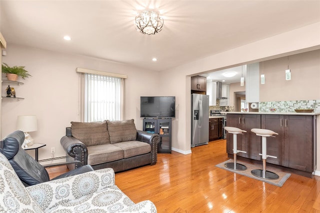 102 Spruce Ln, Valley Stream, NY 11581 - living area featuring baseboard heating, light wood finished floors, recessed lighting, and baseboards