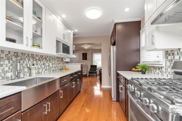 102 Spruce Ln, Valley Stream, NY 11581 - kitchen with appliances with stainless steel finishes, premium range hood, light countertops, and recessed lighting