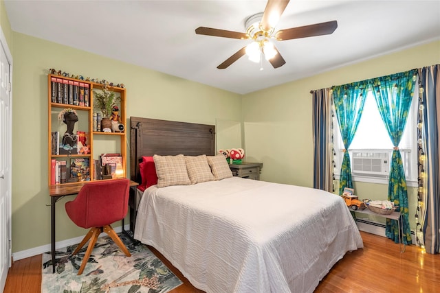 102 Spruce Ln, Valley Stream, NY 11581 - bedroom with wood finished floors, cooling unit, and a ceiling fan