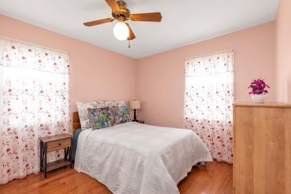 102 Spruce Ln, Valley Stream, NY 11581 - bedroom with wood finished floors and a ceiling fan