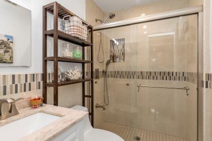 102 Spruce Ln, Valley Stream, NY 11581 - full bathroom with vanity, toilet, and a stall shower
